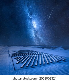 Milky Way Over Snowy Photovoltaic Farm. Alternative Energy, Poland, Europe