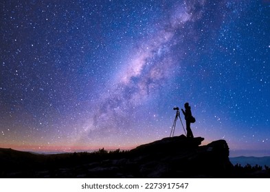 Milky Way and photographer silhouette. Travel, exploring and wanderlust concept. - Powered by Shutterstock