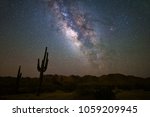 The Milky Way shines above the Arizona desert landscape.