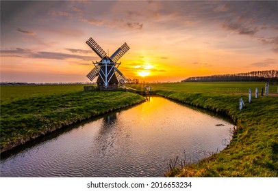 Mill by the river at sunset - Shutterstock ID 2016653234
