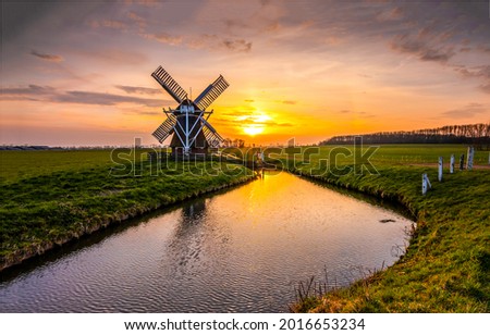 Mill by the river at sunset