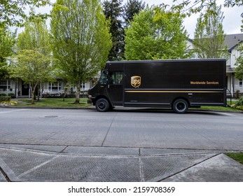 Mill Creek, WA USA - circa May 2022: Front view of a UPS brown delivery truck outside of a residential home, making a delivery.