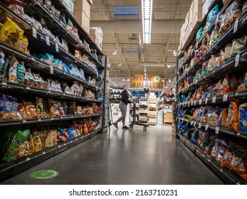 Mill Creek, WA USA - Circa May 2022: View Of A Hispanic Woman Pushing Her Shopping Cart By The Potato Chip Aisle Inside A Town And Country Grocery Store.