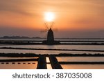 Mill of salt at sunset