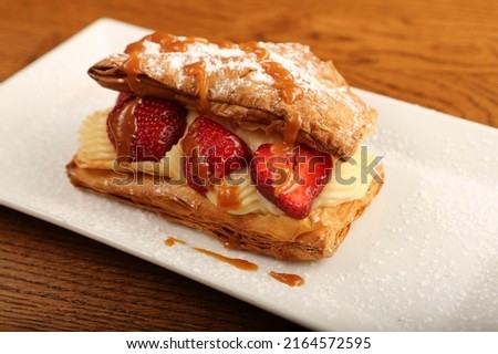 Mille-feuille of puff pastry with raspberries, strawberries