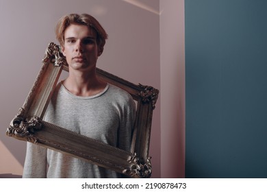 Millenial Young Man Artist With Blonde Hair On Gilded Picture Frame Portrait.