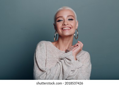 Millenial young woman with short blonde hair smiling portrait