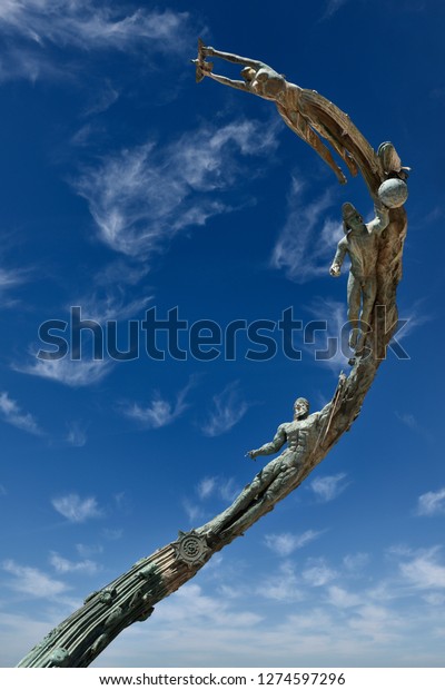 The Millennia sculpture of evolutionary and human\
history against a blue sky on the Malecon Puerto Vallarta, Mexico -\
March 13, 2016