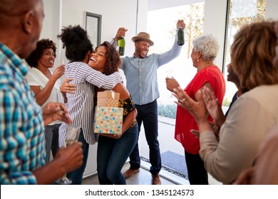 Millennial black couple arriving at a family party with gifts and champagne, close up - Shutterstock ID 1345124573