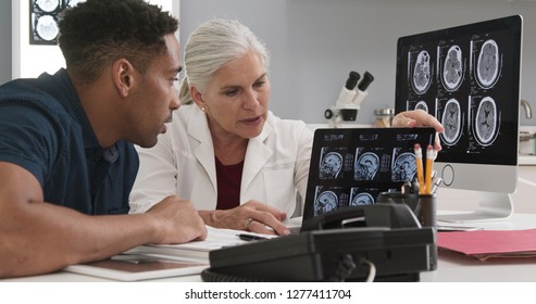 Millennial Black Patient Consulting With Senior Doctor About Concussion