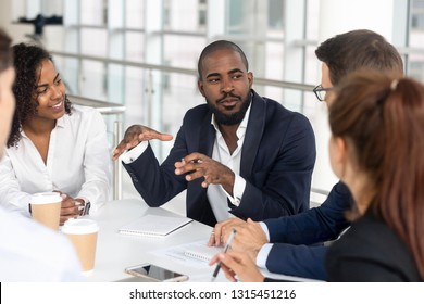 Millennial employees gathered in boardroom for training, black boss ceo leader leading corporate team during seminar learning at modern office. Internship and leadership coaching and education concept