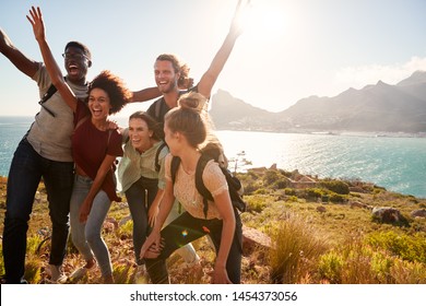 Millennial Friends On A Hiking Trip Celebrate Reaching The Summit And Have Fun Posing For Photos