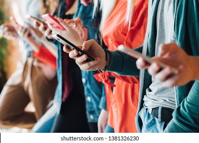 Millennial Generation. Colorful Cropped Closeup Of Young People Holding Smartphones. Modern Devices. Technological Progress.