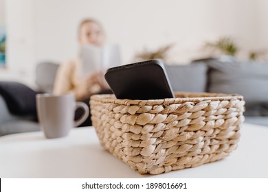 Millennial girl at home refuse using phone and reading a book. Social media addiction. Waste of time. Unplugged. Dependance concept - Shutterstock ID 1898016691