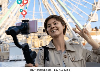 Millennial hipster teen girl blogger influencer record vlog on smart phone holf selfie stick. Travel vlogger shoot video blog instagram story,streaming on urban city street get likes and hearts emoji.