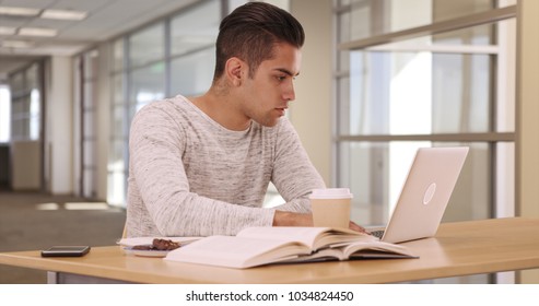 Millennial Latino University Student In Dorm Working On Laptop