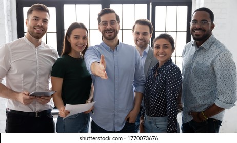 Millennial male leader stretch out his hand for handshake welcoming new employee invites newcomer to corporate team, group showing amity, human resources, boss greets clients express respect concept - Shutterstock ID 1770073676