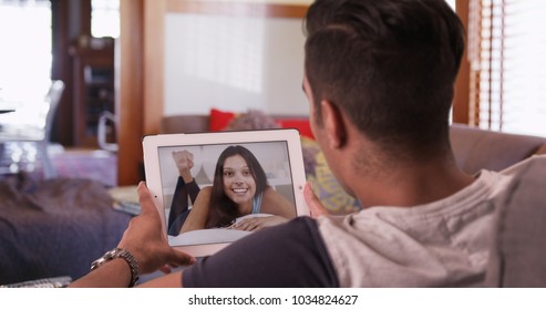 Millennial Man Video Chatting Or Having A Facetime Conversation With His Girlfriend On Tablet Computer