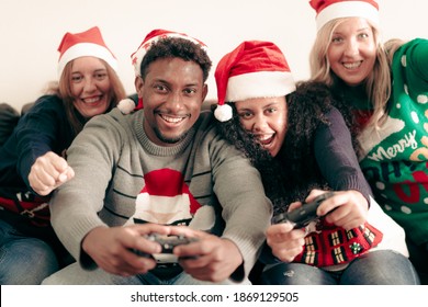 Millennial People Having Fun With Video Games Console On Christmas Time.  Family Playing Video Games All Day In The Apartament. Christmas And Technology Concept.