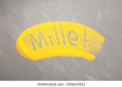 Millet Coarse Flour On Grey Background. Yellow Ground Culinary. Inscription Millet.