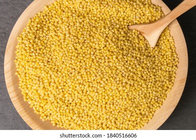 Millet Groats In Wooden Bowl. Nutrition Bio. Natural Food Ingredient.