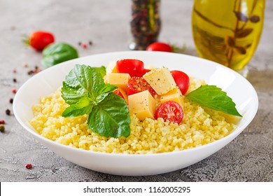 Millet Porridge With Cheese, Butter And Basil In White Bowl. Tasty Food. Breakfast.