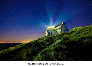 The Millier point lighthouse under a starry clear sky, Brittany, France - Powered by Shutterstock