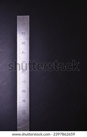 Millimeter Centimeter Steel Scale black Background Copyspace. High quality photo