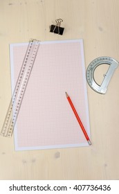 Millimetre Paper With Rulers And A Pencil On A Wooden Table