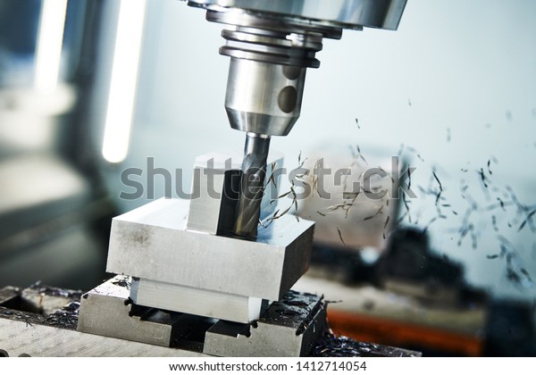 milling cnc machine at\
metal work industry. Multitool precision machining. Shallow depth\
of view on shavings