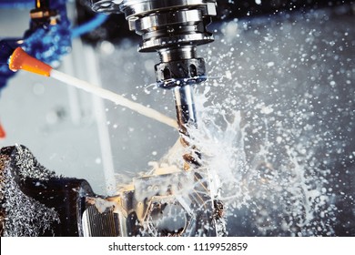 Milling metalworking process. Industrial CNC metal machining by vertical mill. Coolant and lubrication