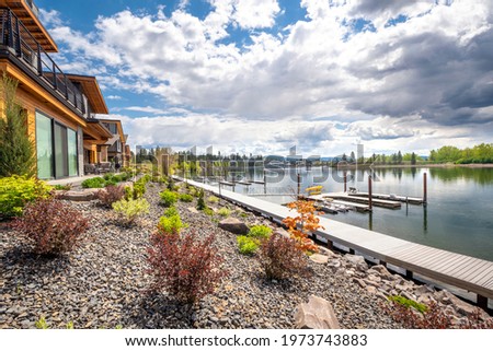 Million dollar waterfront homes along the Spokane River near lake Coeur d'Alene, in the mountain resort town of Coeur d'Alene, Idaho, USA.