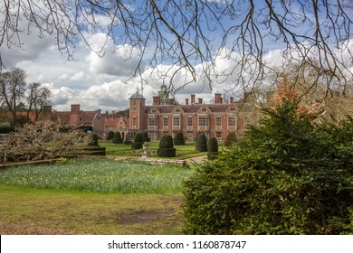 Millionaire Mansion. A Typical English Red Brick Country Estate Manor House With Formal Gardens. Details Including Dutch Gable And Topiary Bushes. High Society Old Money.