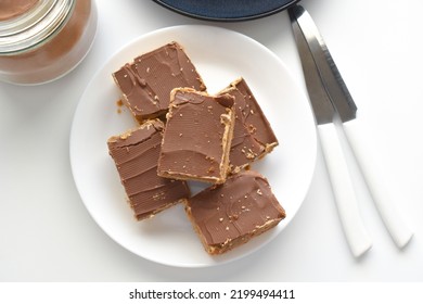 Millionaire's shortbread, caramel shortcake, or millionaire's slice on a white plate.