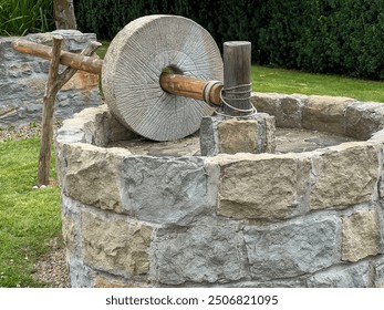 The millstone, olive oil press squeeze out olive oil presented at the Biblical Garden in Muszyna, Poland. - Powered by Shutterstock