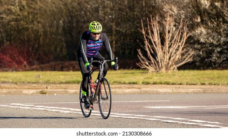 Milton Keynes, Bucks, UK - Feb. 27th 2022. Cyclist Wearing Lycra And Cycling Helmet