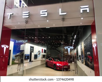 Milton Keynes, UK - 10 October 2018: A Tesla Elon Musk Company Sign Outside A Electric Autonomous Car Of The Future Transportation Store Dealership In A Shopping Mall Selling Smart New Vehicles.