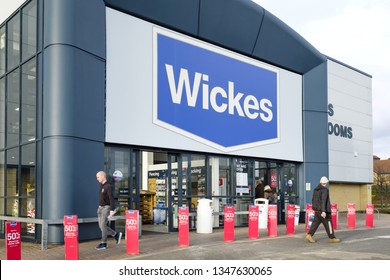 Milton Keynes, UK - February 11, 2019. Customers Enter A Wickes DIY Store. Wickes Is A Home Improvement Retailer In The UK Owned By Travis Perkins Plc.