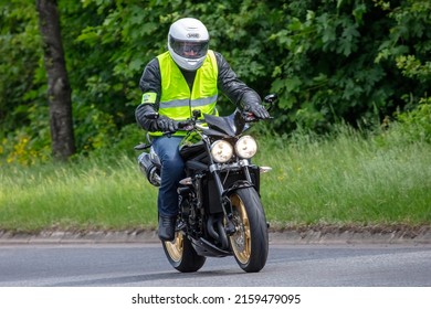 Milton Keynes,Bucks,UK - May 22nd 2022. Man In Hi Viz Jacket Riding A Triumph Motorcycle