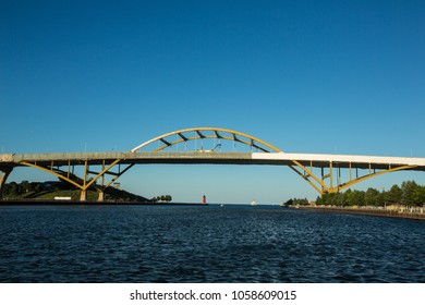 Milwaukee Hoan Bridge At Sunset, With Third Ward Pier Light