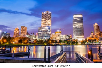 Milwaukee Skyline At Night With Reflection In Lake Michigan.