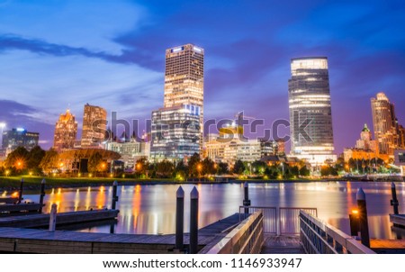 milwaukee skyline at night with reflection in lake michigan.