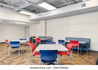 MILWAUKEE, WI, USA - MARCH 4, 2021: A Colorful Office Break Room With A Hardwood Floor, Colorful Chairs, And Tables.