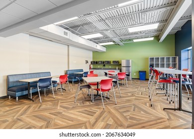 MILWAUKEE, WI, USA - MARCH 4, 2021: A Colorful Office Break Room With A Hardwood Floor, Colorful Chairs, And Tables.