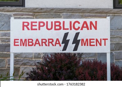 Milwaukee, Wisconsin - 06/24/20: Anti Trump Signs Posted In A Yard. The Signs Give Reference To The Nazis Through Both The Swastika And The SS Logo Of The Schutzstaffel