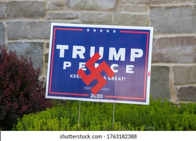 Milwaukee, Wisconsin - 06/24/20: Anti Trump Signs Posted In A Yard. The Signs Give Reference To The Nazis Through Both The Swastika And The SS Logo Of The Schutzstaffel