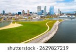 Milwaukee Wisconsin city skyline with modern skyscrapers captured from Lakeshore State Park along Lake Michigan waterfront.