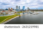 Milwaukee Wisconsin city skyline with modern skyscrapers captured from Lakeshore State Park along Lake Michigan waterfront.