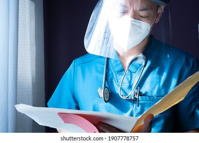 Milwaukee, Wisconsin - February 1, 2021: Male Nurse Reviewing A Patient Chart