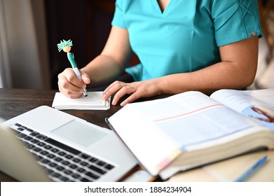 Milwaukee, Wisconsin - November 20, 2020: a female Nursing student studying for a finals exam in front of a laptop and book